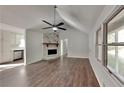 Bright living room featuring a stone fireplace, wood floors, and vaulted ceiling at 130 Fairview Dr, Stockbridge, GA 30281