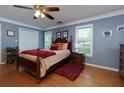 Cozy bedroom with hardwood floors, a ceiling fan, and abundant natural light from the windows at 3420 Sweetbriar Ln, Powder Springs, GA 30127