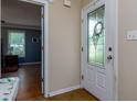 Foyer leading to a bedroom, showcasing a decorative glass front door and neutral wall paint at 3420 Sweetbriar Ln, Powder Springs, GA 30127