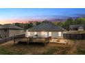 Enjoy outdoor living with a wooden deck and stone patio in a private backyard with mature trees at 313 Bonnie Sue Dr, Villa Rica, GA 30180