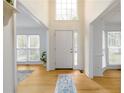 Bright, open foyer with hardwood floors and a view of the living spaces at 1885 Oak Wind Ln, Buford, GA 30519