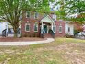 Charming two-story brick home with a covered front porch and landscaped yard at 2210 Holly Springs Rd, Rockmart, GA 30153