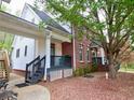 Side view of a brick house, complemented by a wooden porch and a well-maintained landscape at 2210 Holly Springs Rd, Rockmart, GA 30153