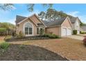 A well-maintained single-story home with a manicured lawn and a two-car garage at 475 Brown Thrasher Ct, Alpharetta, GA 30009