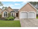 Charming single-story home with a manicured lawn, double garage, and inviting front entrance at 475 Brown Thrasher Ct, Alpharetta, GA 30009