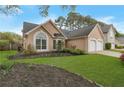 Inviting single-story home showcasing a well-manicured lawn, landscaping, and a two-car garage at 475 Brown Thrasher Ct, Alpharetta, GA 30009