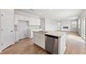 Open concept kitchen with a center island, stainless steel appliances, and hardwood floors at 7182 Brushwood Bend (Lot 114), Lithonia, GA 30058