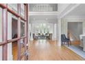 Grand foyer with hardwood floors, decorative columns, and an open view to the living room at 2281 Bransley Pl, Duluth, GA 30097