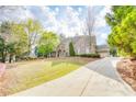 Beautiful brick home with a well-manicured lawn and long driveway, showcasing curb appeal at 2281 Bransley Pl, Duluth, GA 30097