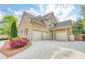 Spacious three-car garage with a long driveway and well-maintained landscaping at 2281 Bransley Pl, Duluth, GA 30097