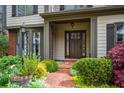 Inviting front porch with brick walkway, manicured landscaping, and a stylish entry door at 4688 Oakleigh Manor Dr, Powder Springs, GA 30127