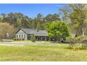 Attractive single-Gathering home on a spacious lot with lush landscaping, attached covered car port, and charming covered porch at 6585 Queen Mill Se Rd, Mableton, GA 30126
