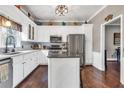 Bright kitchen with stainless steel appliances, white cabinetry, dark countertop and an island at 6585 Queen Mill Se Rd, Mableton, GA 30126