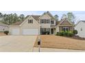 Traditional two-story home featuring a two-car garage and manicured lawn at 122 Crestmont Dr, Canton, GA 30114