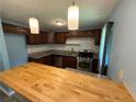 The kitchen features stainless steel appliances, tile backsplash, gas range, and granite counters at 1464 Colony East Cir, Stone Mountain, GA 30083
