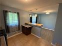 Bright kitchen featuring a tile floor, stainless steel appliances, a breakfast bar, and lots of natural light at 1464 Colony East Cir, Stone Mountain, GA 30083