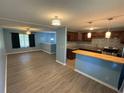 A spacious living room with hardwood flooring flowing seamlessly into an open kitchen with stainless steel appliances at 1464 Colony East Cir, Stone Mountain, GA 30083