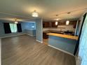 Open concept living room features new floors, neutral paint, and updated kitchen with breakfast bar at 1464 Colony East Cir, Stone Mountain, GA 30083