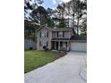 Charming two-story home with a well-manicured lawn and driveway at 230 Blue Heron Dr, Jonesboro, GA 30238