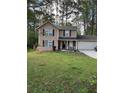 Charming two-story home with a well-manicured lawn and attached two-car garage at 230 Blue Heron Dr, Jonesboro, GA 30238