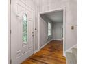 Bright foyer showcases hardwood floors and an elegant front door with decorative glass at 4606 Greensprings Rd, College Park, GA 30337
