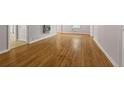 Open living room features gleaming hardwood floors and neutral paint, offering a versatile living space at 4606 Greensprings Rd, College Park, GA 30337