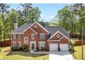A lovely two-story red brick home with well-maintained landscaping, a driveway, and a basketball hoop at 5296 Camden Lake Nw Pkwy, Acworth, GA 30101