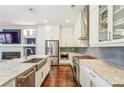 Modern kitchen with stainless steel appliances, stone countertops, and white cabinets at 828 Canterbury Overlook Ne, Atlanta, GA 30324