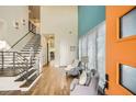 Bright entryway with sleek staircase, modern railings, and a vibrant orange door at 4225 Maner Se St, Smyrna, GA 30080