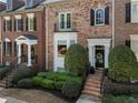 Brick townhouse exterior with neat landscaping, black shutters, and welcoming front entrance at 2630 Milford Ln, Alpharetta, GA 30009