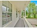 View of the covered porch with gray flooring and white railing for relaxing at 111 Evergreen Trl, Cartersville, GA 30121