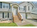 View of the home's front entrance with stairs, a white door, manicured lawn, and RV Parking at 1218 Cabots Ln, Auburn, GA 30011