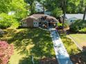 Inviting single-story home with well-maintained lawn, private driveway, and mature shade trees at 1629 Anita Ne Pl, Atlanta, GA 30306