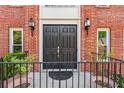 Close-up of the elegant double front doors with decorative lanterns and wrought-iron railings at 2804 Livsey Woods Dr, Tucker, GA 30084