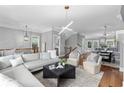 An open concept living room with modern decor and adjacent dining area and kitchen at 2528 Magnolia Ridge Dr, Marietta, GA 30067