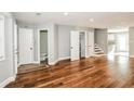 Open-plan living room boasting hardwood floors, grey walls, and hallway access to a bathroom at 6331 Wedgeview Dr, Tucker, GA 30084