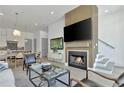 Bright living room with fireplace and an open floor plan to kitchen featuring hardwood floors and modern furnishings at 190 Rolison Way, Fayetteville, GA 30214