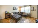 Cozy living room with a large sectional, ottoman, decorative pillows, and a patterned area rug on hardwood floors at 2232 Dunseath Ave # 407, Atlanta, GA 30318