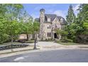 Charming stone and brick home with porte-cochere on a tree-lined street at 854 Club Moss Ct, Marietta, GA 30068