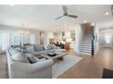 Open-concept living space with hardwood floors, a modern ceiling fan, and abundant natural light at 920 Wemberley Ln, Marietta, GA 30064