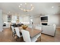 Bright and airy living space with modern lighting and seamless flow to the kitchen and dining area at 920 Wemberley Ln, Marietta, GA 30064