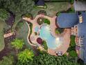 Beautiful backyard with sparkling pool, landscaped patio area, lush greenery, and relaxing lounge chairs at 1319 Glen Cedars Dr, Smyrna, GA 30126
