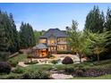 Stunning backyard featuring a spacious patio, sparkling pool with waterfall, and lush landscaping at 1319 Glen Cedars Dr, Smyrna, GA 30126
