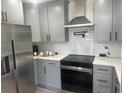 Modern kitchen boasts gray cabinets, stainless steel appliances, and sleek quartz countertops at 1841 Bayberry Sw Dr, Atlanta, GA 30311