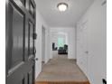 Bright foyer features neutral decor, wood floors, and an inviting view of the living space at 2793 Saddle Horn, Snellville, GA 30039