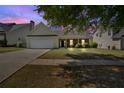 Inviting single-story home with an attached two-car garage, landscaped yard, and a tree-lined street at 2793 Saddle Horn, Snellville, GA 30039