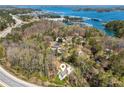 Stunning aerial view of the property location, nestled amongst trees with waterfront access and nearby marinas at 3143 Lee Cir, Buford, GA 30518