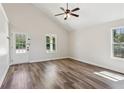 Bright living room with hardwood floors, high ceilings, and a door leading to a covered patio at 3143 Lee Cir, Buford, GA 30518