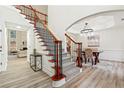 Bright foyer showcasing a staircase with wood and wrought iron, plus stylish flooring and decor at 4419 Bellwood Cir, Atlanta, GA 30349