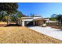 Modern home showcasing a long driveway, sleek design and well-maintained front yard at 2526 Abner Nw Pl, Atlanta, GA 30318
